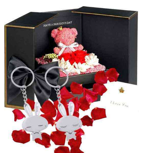 a teddy bear in a gift box surrounded by roses