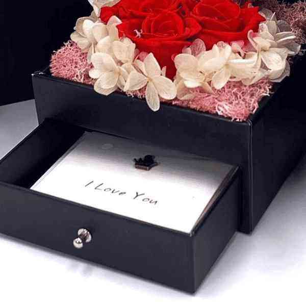 a black box with a red rose in it