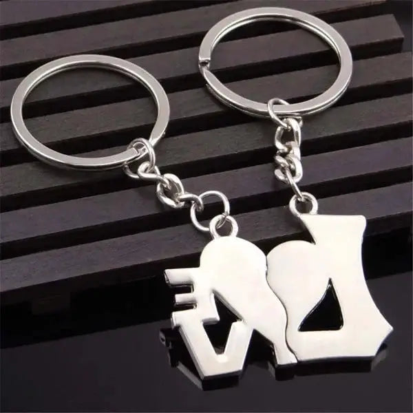 two key chains with the word love on them