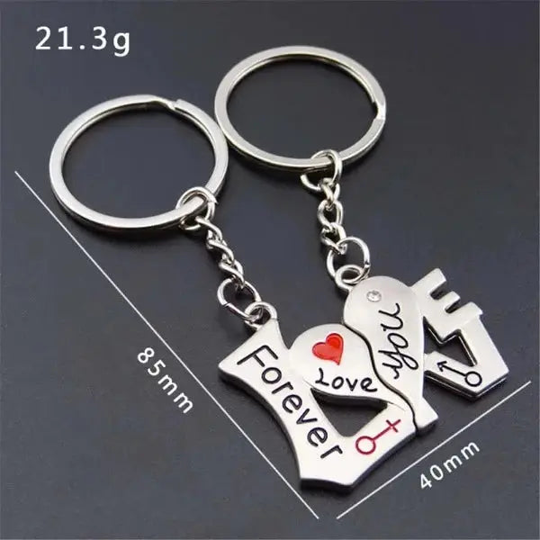 a couple of key chains with a heart and a house