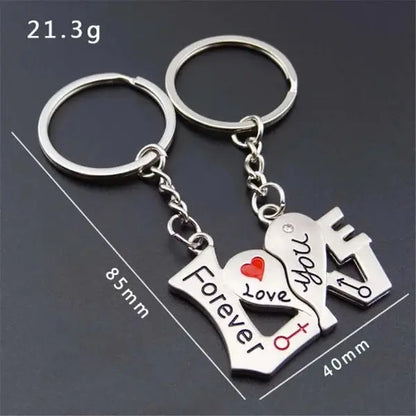 a couple of key chains with a heart and a house