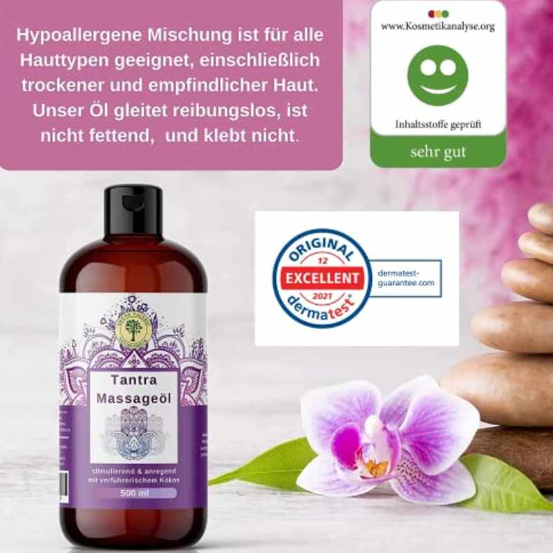 a bottle of massage oil next to a purple flower