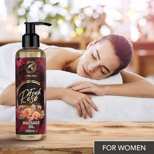 a woman laying on a bed next to a bottle of body lotion