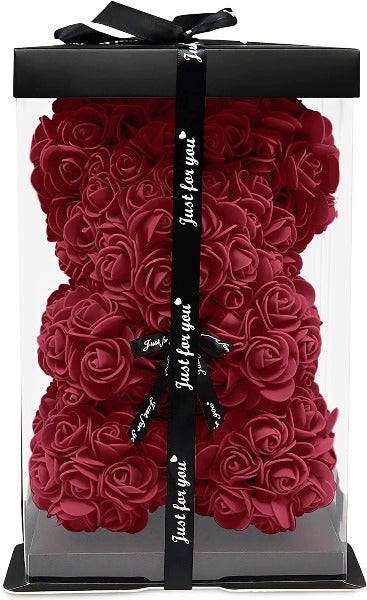 a clear box with red roses inside of it